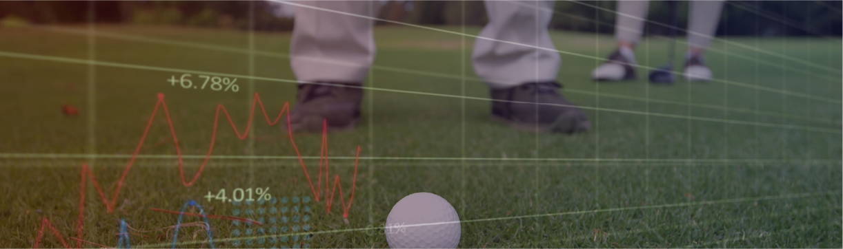 Close-up of a golf ball on the grass with the feet of a golfer in the background